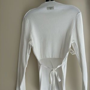 Aritzia white mock neck ribbed sweater with back cut out.